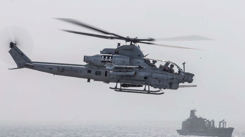 PHOTO:  An AH-1Z Viper helicopter prepares to land onto the flight deck of the amphibious assault ship USS Boxer during a strait transit, July 18, 2019.