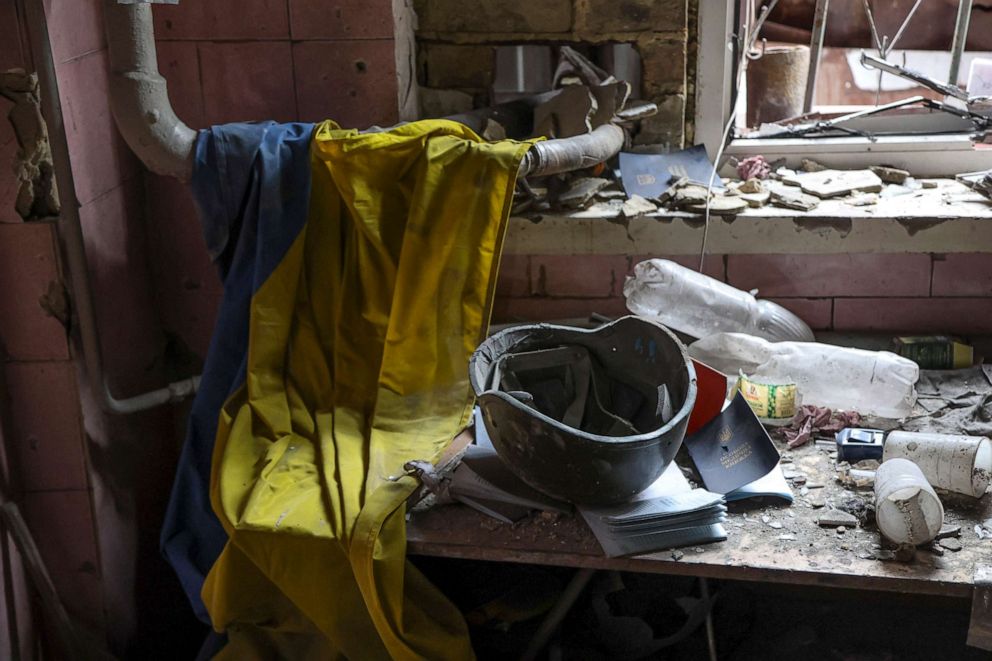 PHOTO: A Ukrainian national flag, military helmet and medical documents lie on a table at a destroyed part of the Illich Iron & Steel Works Metallurgical Plant, in Mariupol, Ukraine, April 18, 2022.
