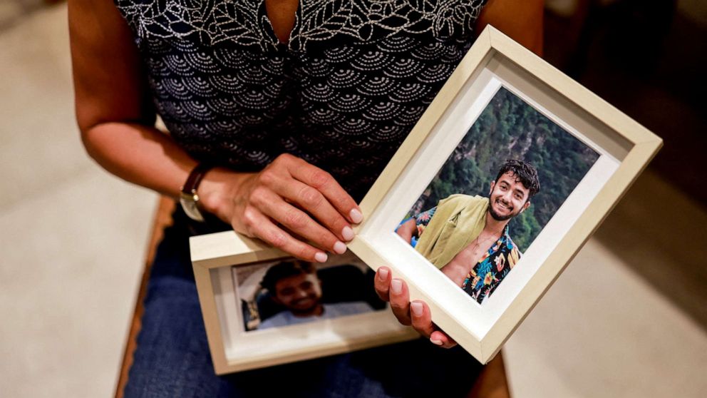 PHOTO: Rachel Goldberg, U.S.-Israeli mother of Hersh Goldberg Polin, which was taken hostage by Hamas militants into the Gaza Strip while attending a music festival in south Israel, holds photos of her son in their home, in Jerusalem October 17, 2023.