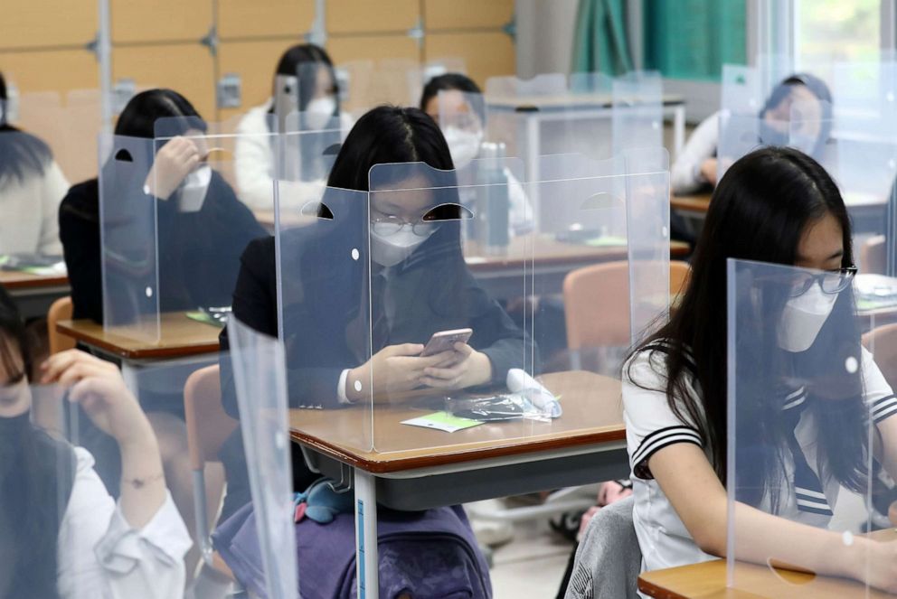 PHOTO: Senior students wait for class to begin with plastic barriers placed on their desks at Jeonmin High School in Daejeon, South Korea, on May 20, 2020.