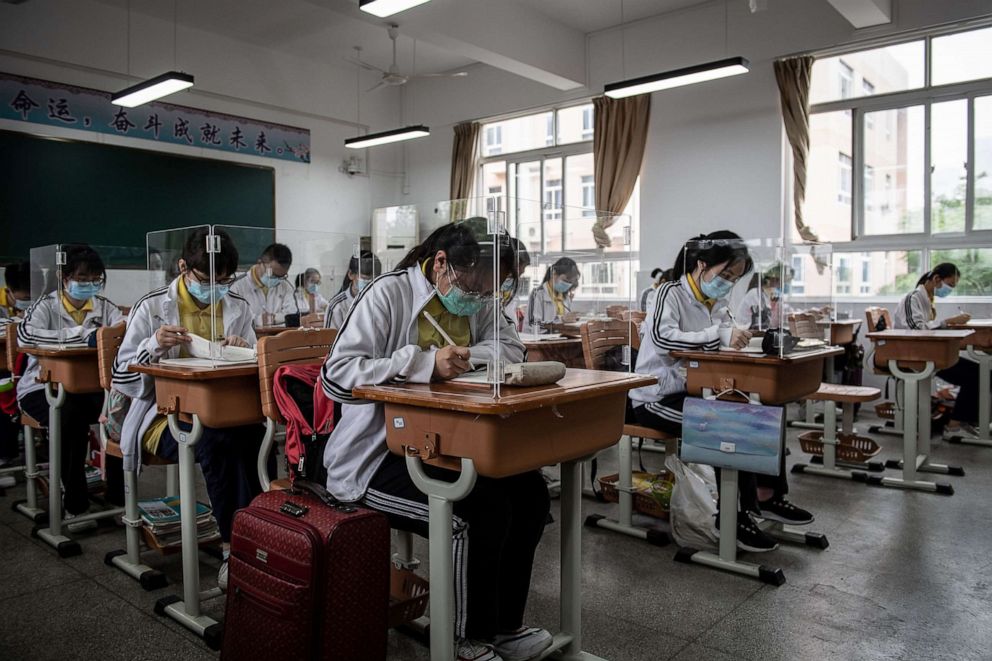 PHOTO: High school senior students study with plastic partitions in a classroom in Wuhan in China's central Hubei province on May 6, 2020.