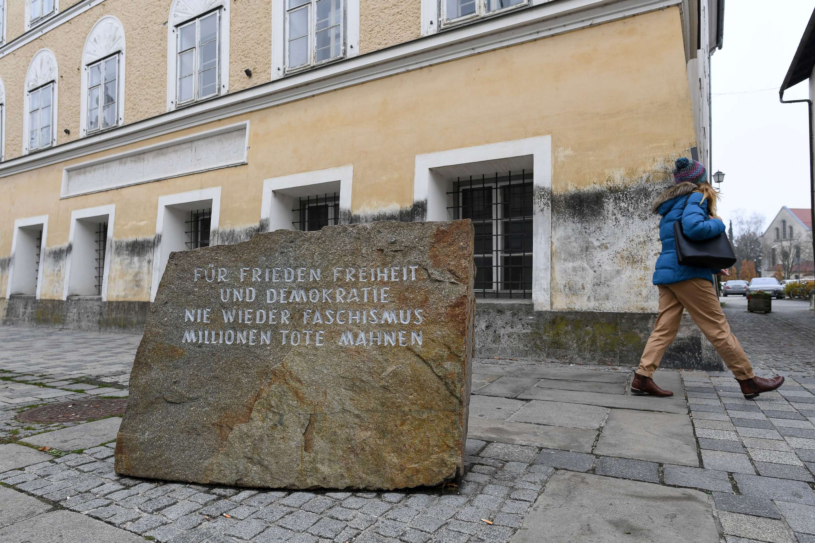 PHOTO: A woman walks past a memorial reading "For peace, liberty and democracy. Never again Fascism" in front the house where Adolf Hitler was born, in Braunau, Austria, Nov. 20, 2019.
