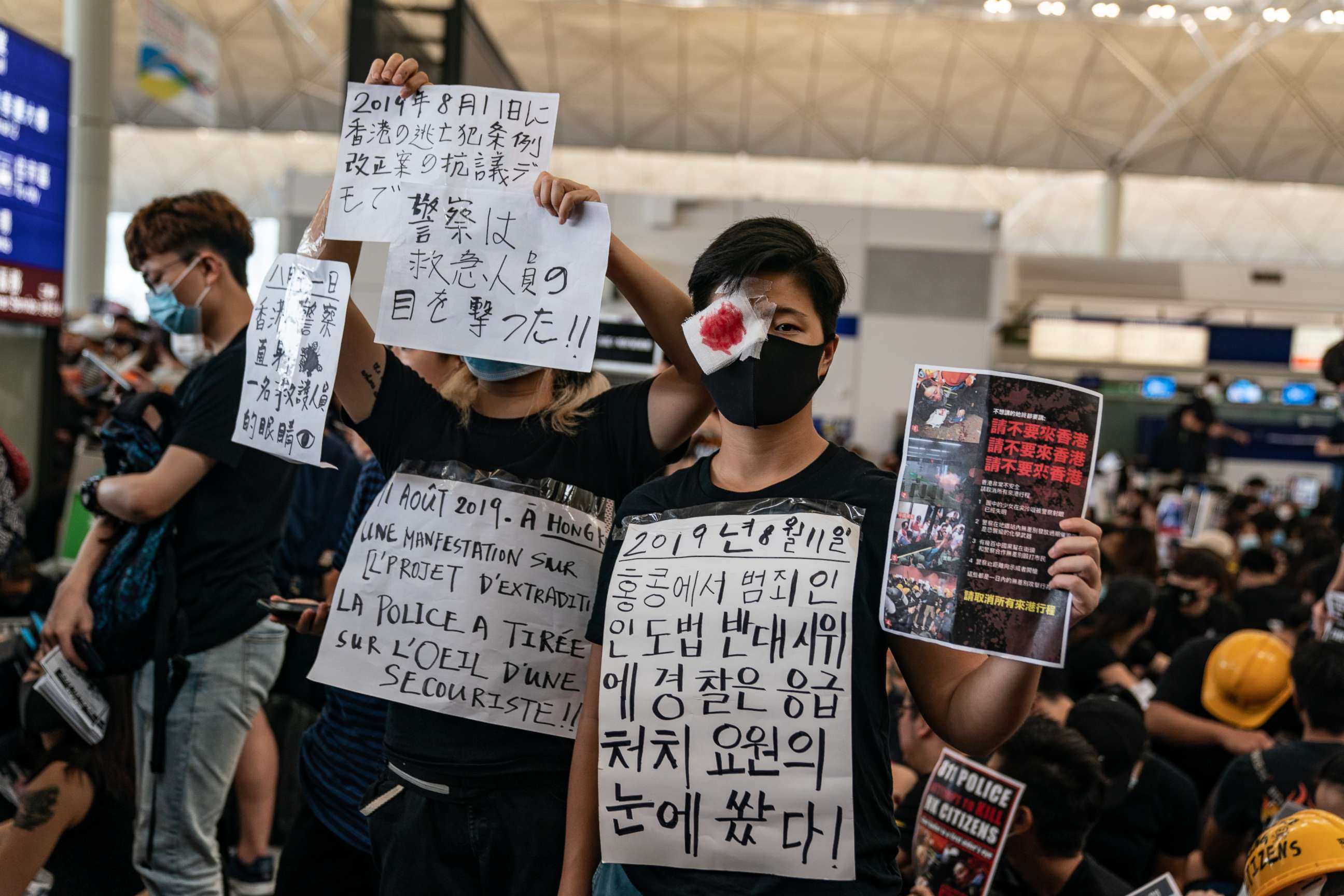 PHOTO: Protesters hold placards as they occupy the arrival hall of the Hong Kong International Airport during a demonstration on Aug. 12, 2019.