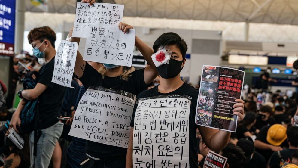 PHOTO: Protesters hold placards as they occupy the arrival hall of the Hong Kong International Airport during a demonstration on Aug. 12, 2019.