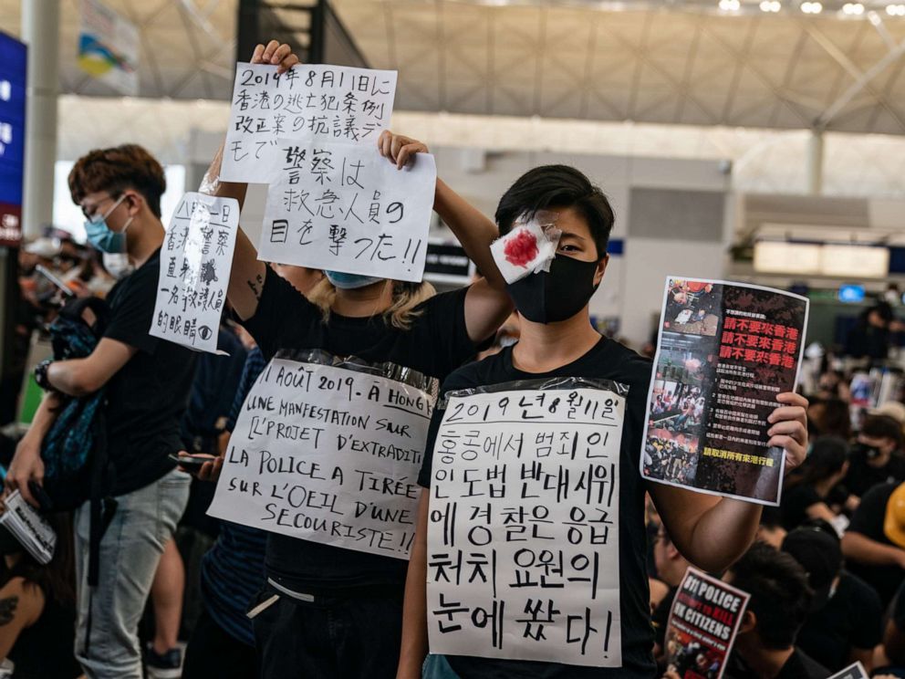 PHOTO: Protesters hold placards as they occupy the arrival hall of the Hong Kong International Airport during a demonstration on Aug. 12, 2019.