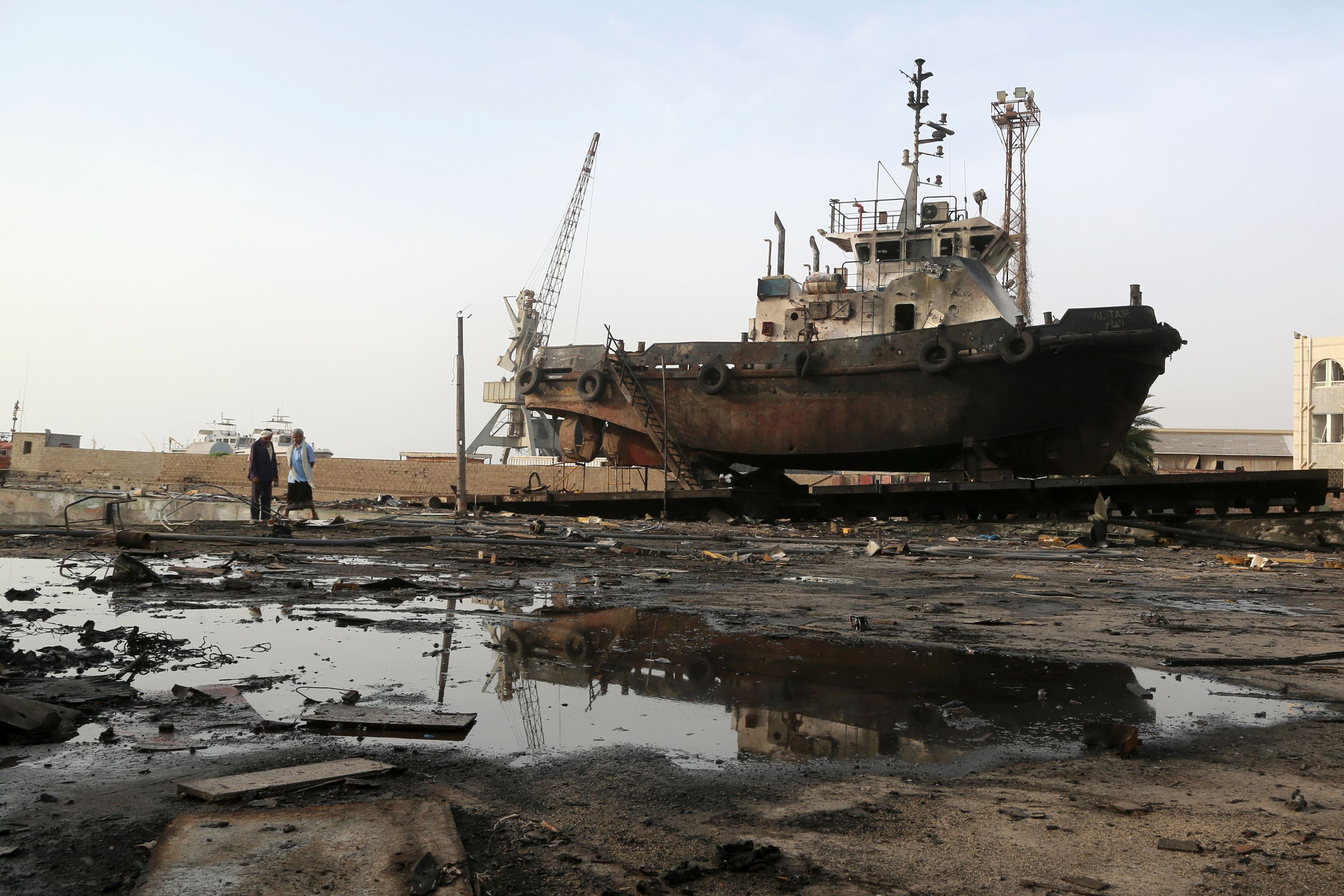 PHOTO: Workers inspect damages at the site of an air strike on the maintenance hub at the Hodeidah port, May 27, 2018.
