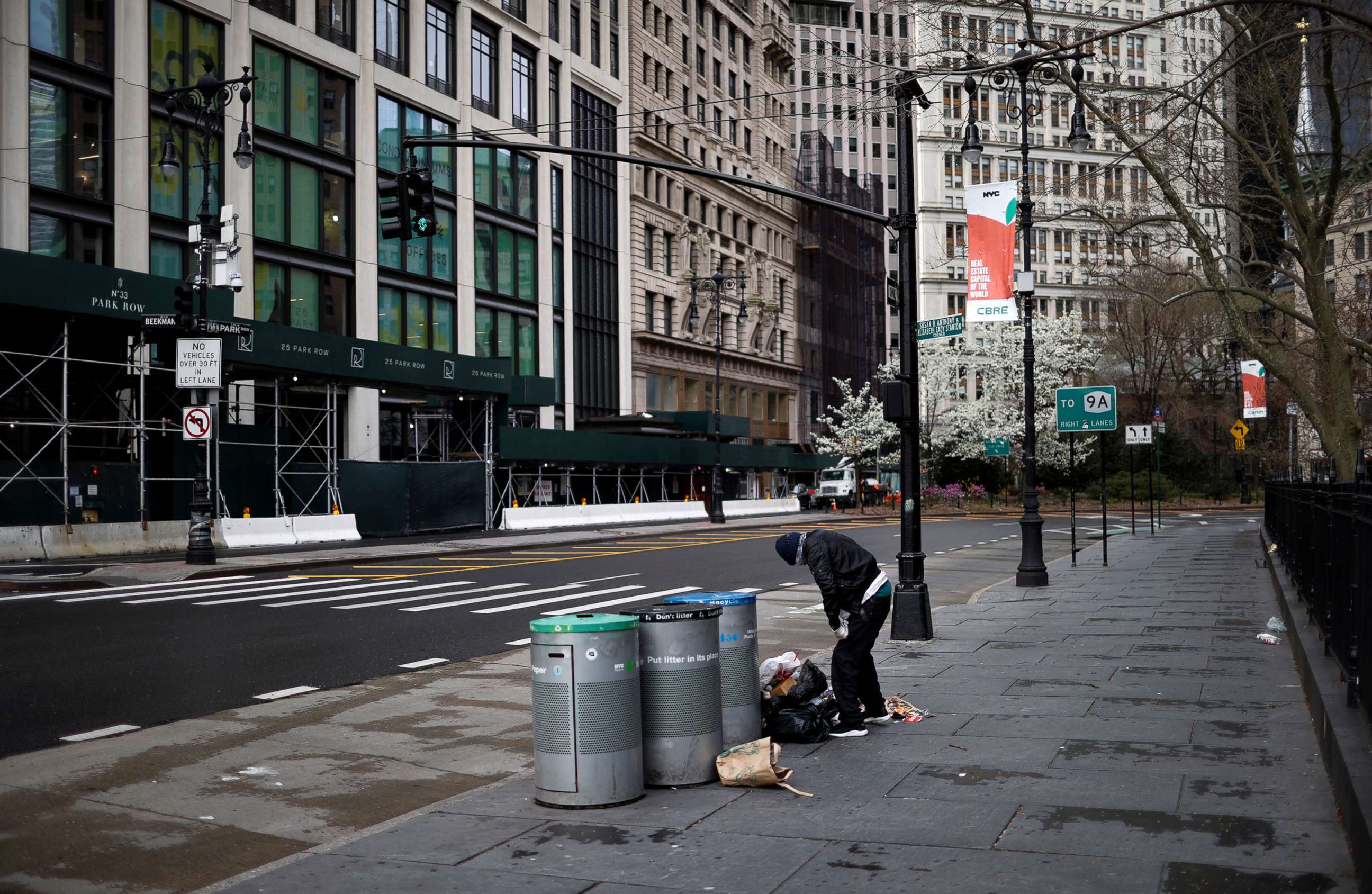 PHOTO: A homeless man sifts through trash on a nearly deserted street in lower Manhattan during the outbreak of the coronavirus disease in New York City, April 3, 2020.