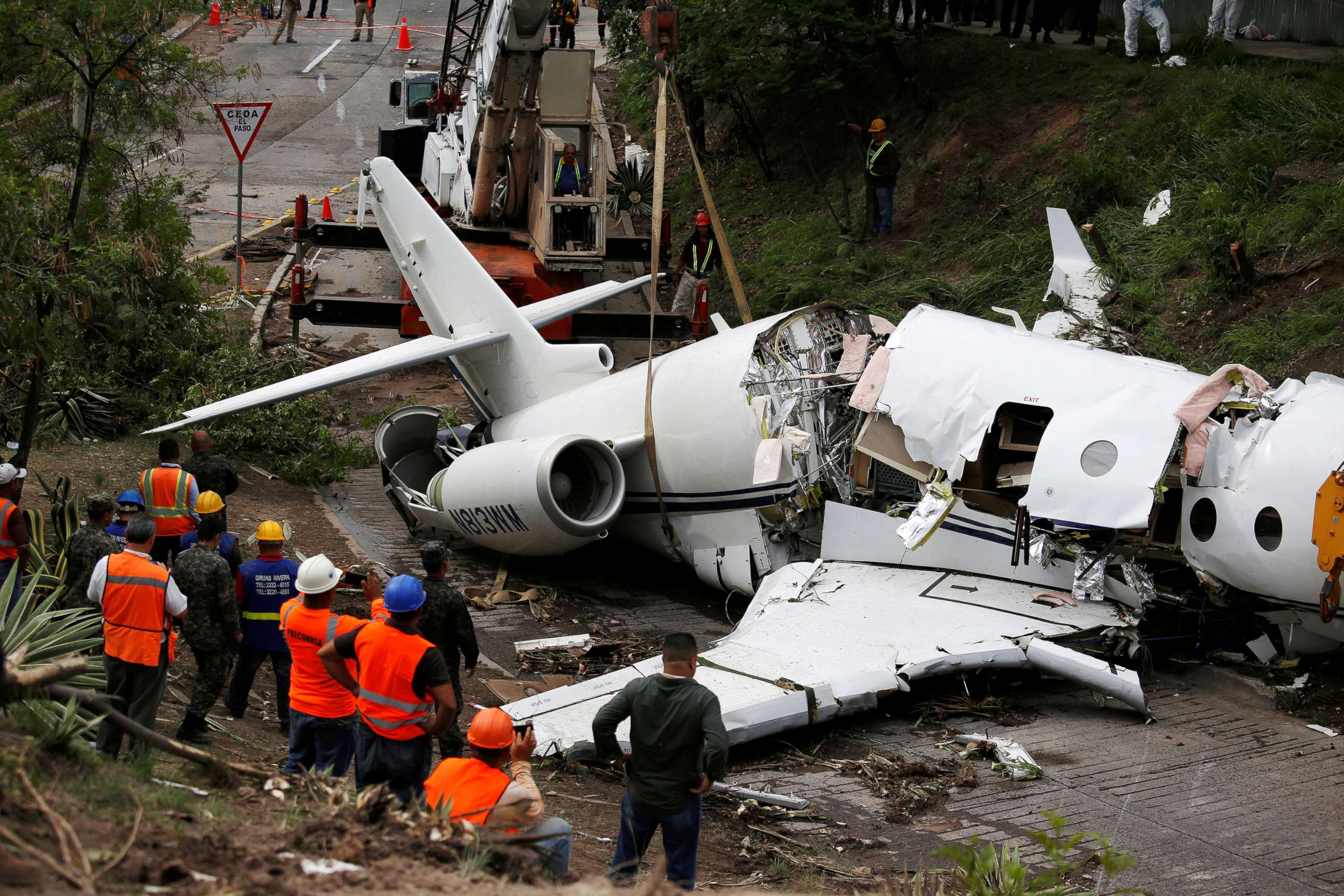 PHOTO: A crane lifts the wreckage of a Gulfstream G200 aircraft that skidded off the runway during landing at Toncontin International Airport in Tegucigalpa, Honduras, May 22, 2018.