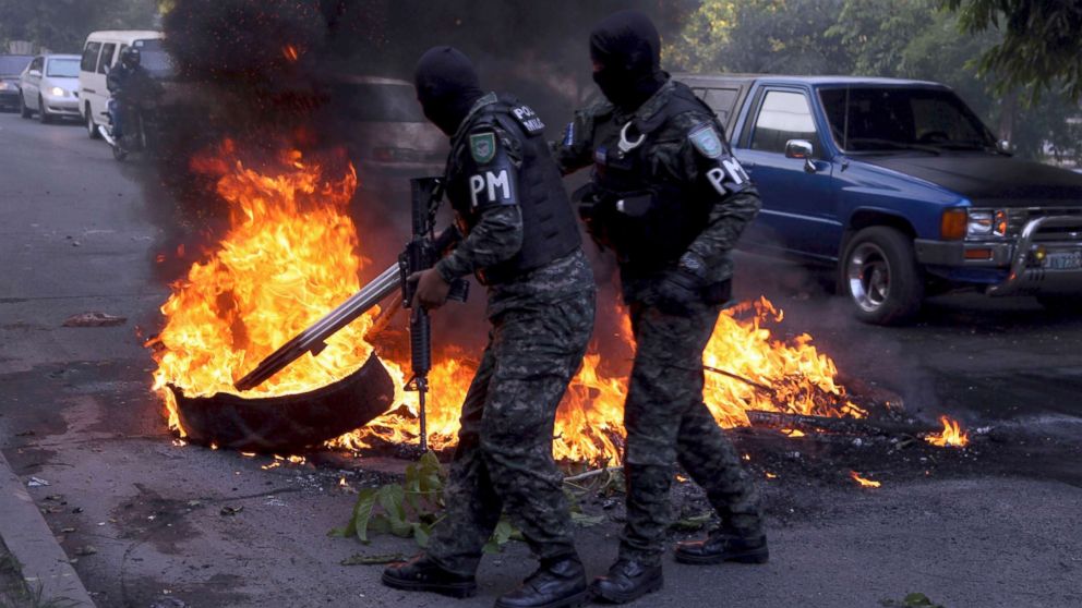 PHOTO: Military police clear a barricade set up by protestors supporting opposition presidential candidate Salvador Nasralla, in the outskirts of Tegucigalpa, Honduras, Dec. 22, 2017.