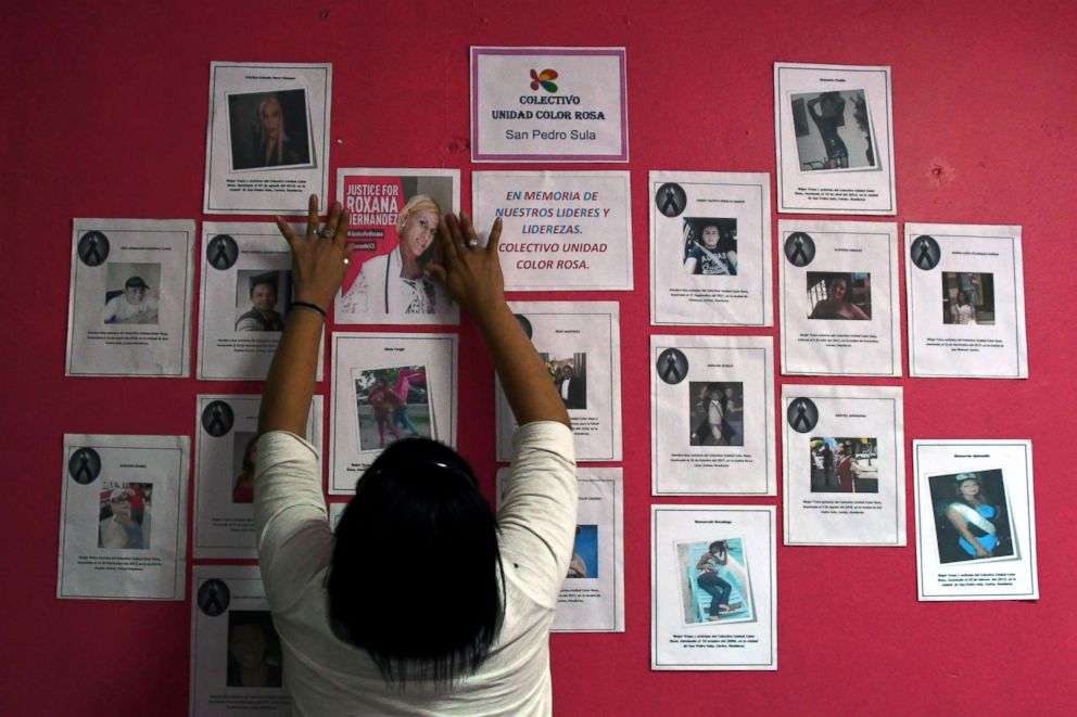 PHOTO: A member of the Pink Unity Collective places a poster on a board, demanding justice in the death of Honduran transgender woman Roxana Hernandez, in San Pedro Sula, on June 3, 2018.