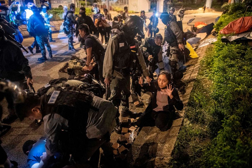 PHOTO: Police detain protesters and students after they tried to flee outside the Hong Kong Polytechnic University campus in the Hung Hom district of Hong Kong on Nov. 19, 2019.