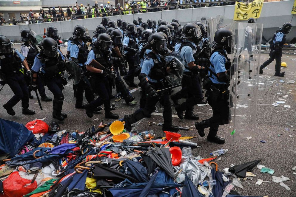 PHOTO: Police advance towards protesters during a rally against a controversial extradition law proposal outside the government headquarters in Hong Kong, June 12, 2019. 