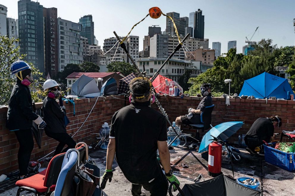 PHOTO: Demonstrators use a catapult to fire a brick at the Hong Kong Polytechnic University, Nov. 17, 2019, in Hong Kong.