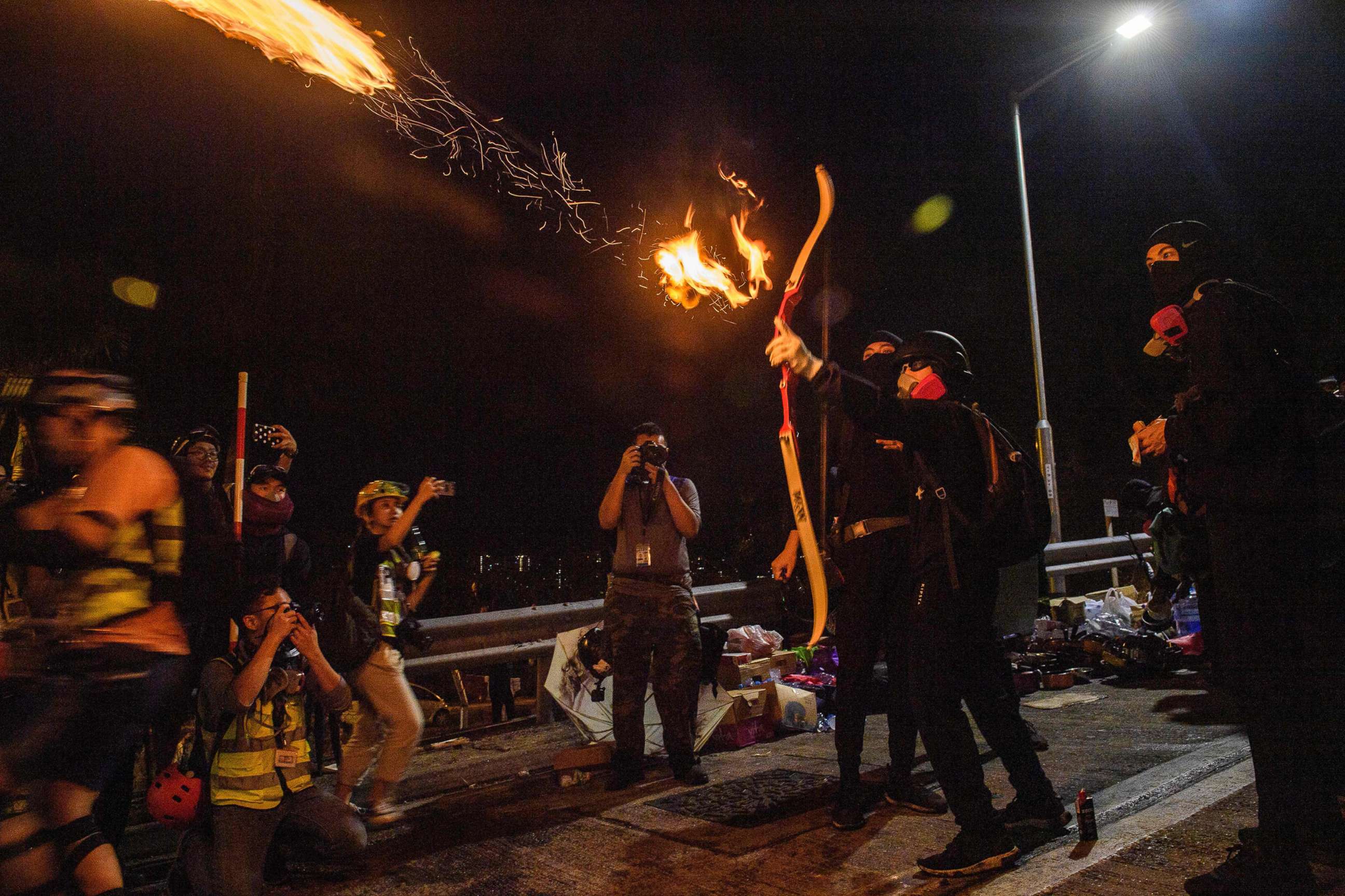 PHOTO: A demonstrator releases a fire arrow with his bow to light a barricade at the Chinese University of Hong Kong (CUHK), in Hong Kong, Nov. 13, 2019.