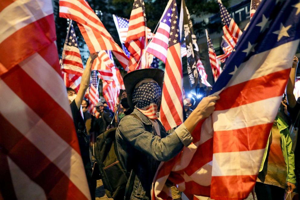 PHOTO: A demonstrator holds a U.S. flag as they attend a rally in Hong Kong, Nov. 28, 2019. 