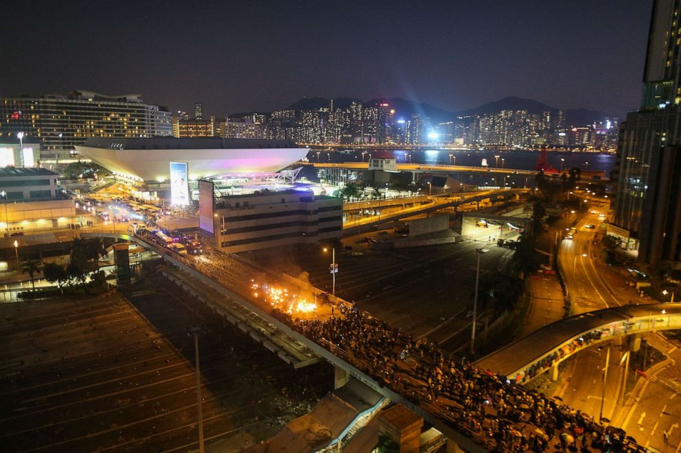 PHOTO: Fire erupts as pro-democracy protesters clash with police on a bridge outside the Hong Kong Polytechnic University in Hong Kong, Nov. 17, 2019.