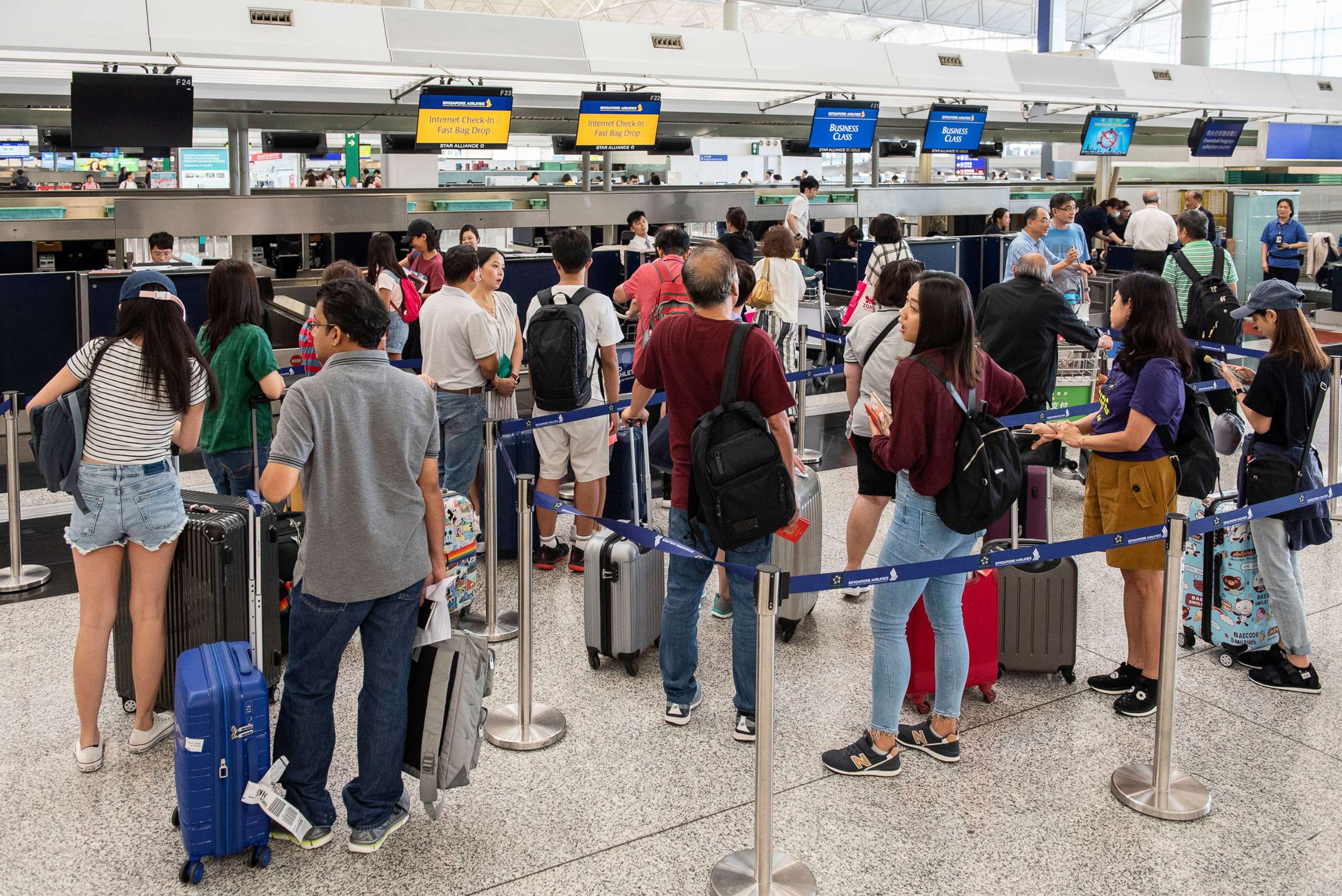 PHOTO: Passengers line up at check in counters at Hong Kong International Airport, Hong Kong, China, August 14, 2019.