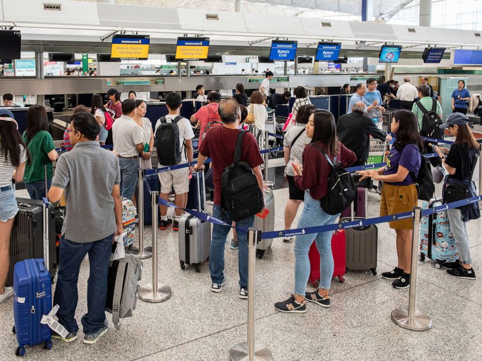 PHOTO: Passengers line up at check in counters at Hong Kong International Airport, Hong Kong, China, August 14, 2019.