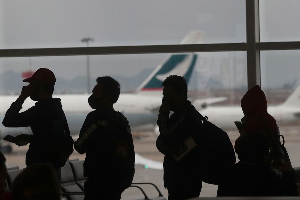 PHOTO: People wearing masks line up for departure at Hong Kong International Airport in Hong Kong, Feb. 4, 2020.