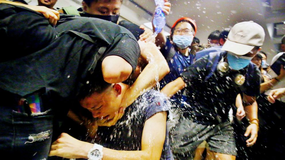 PHOTO: Protesters swarm a man who is suspected of being an undercover policeman at Hong Kong International Airport, Aug. 13, 2019.