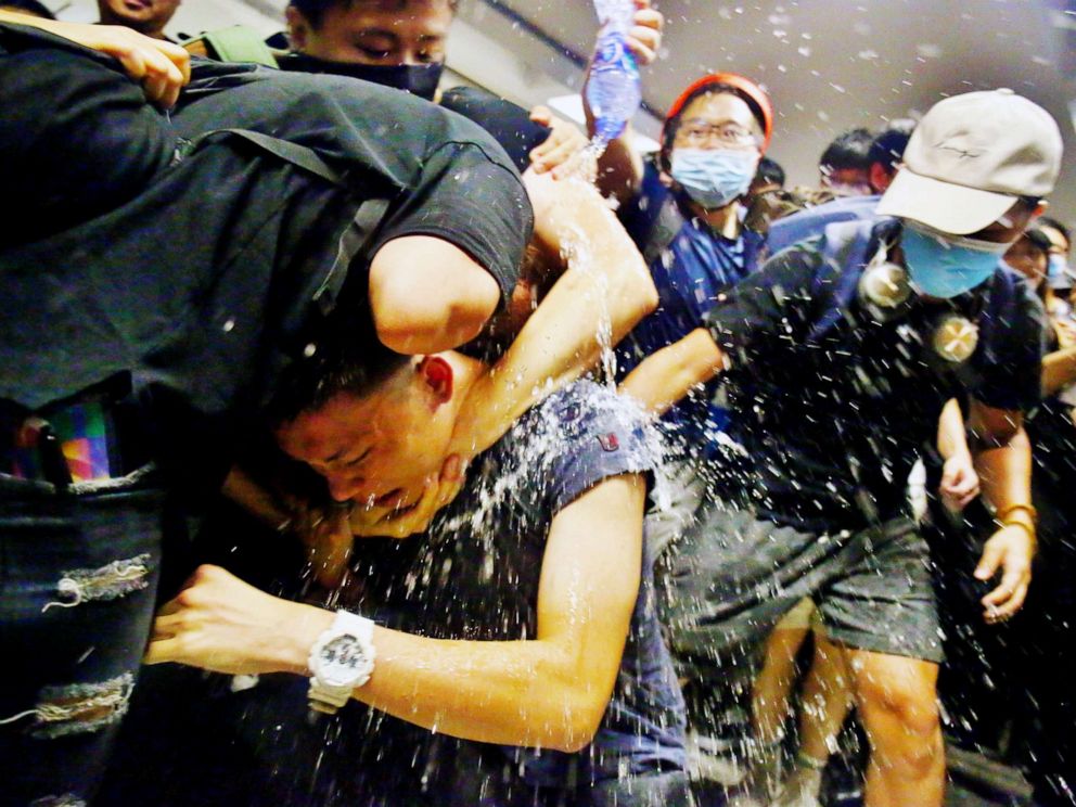 PHOTO: Protesters swarm a man who is suspected of being an undercover policeman at Hong Kong International Airport, Aug. 13, 2019.