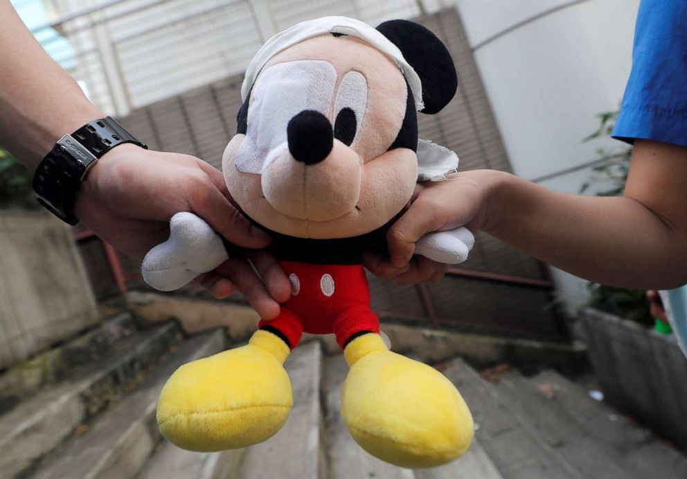 PHOTO: Secondary school students hold a Mickey Mouse doll with an eye patch as they form a human chain in support of pro-democracy protests in Hong Kong, Sept. 9, 2019. They eye patch is a reference to a protester injured during demonstrations.