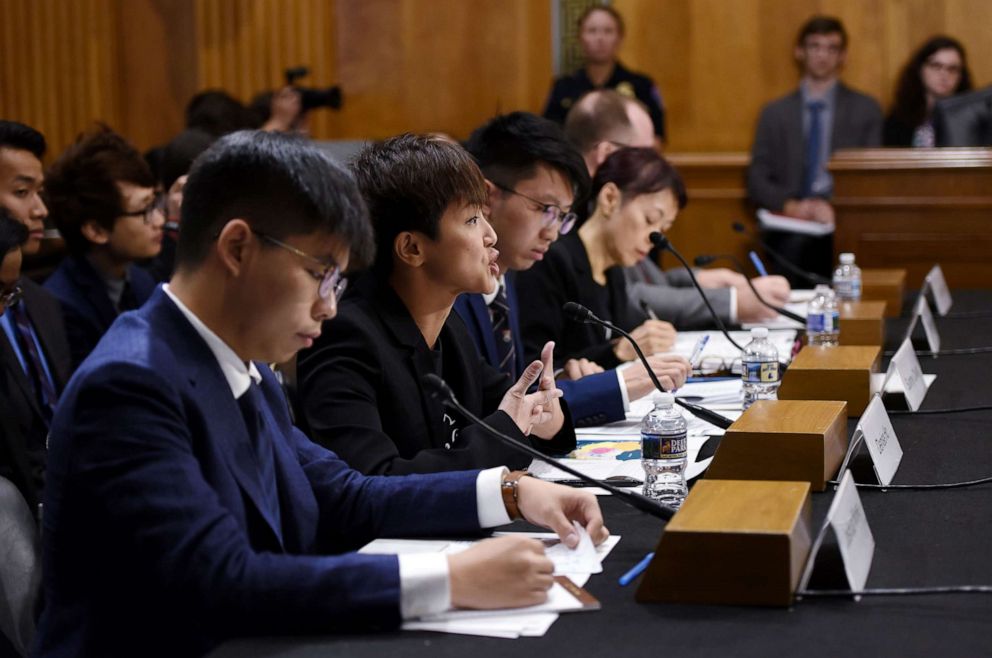 PHOTO: Joshua Wong listens as Denise Ho (C), pro-Democracy activist and Cantopop singer testifies before the Congressional-Executive Commission on China about the pro-democracy movement in Hong Kong, on September 17, 2019, in Washington, D.C.s