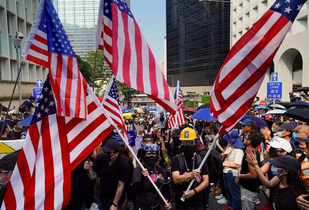 PHOTO: Protesters shout slogans and wave U.S. flags as they march from Chater Garden to the U.S. Consulate in Hong Kong, Sunday, Sept. 8, 2019.