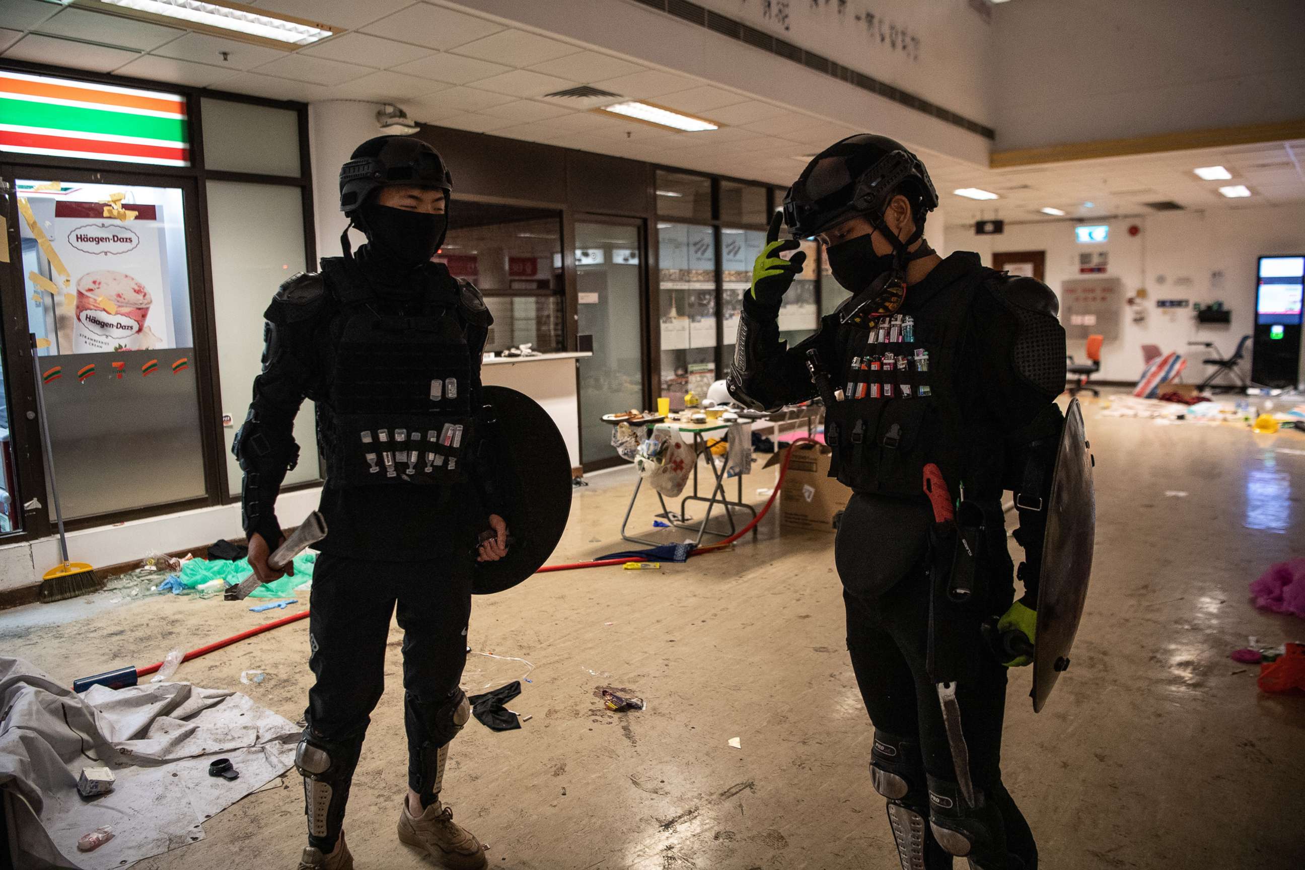 PHOTO: Anti-government protesters with their faces covered stand at Hong Kong Polytechnic University, which has been taken over by anti-government protesters, on Nov. 21, 2019, in Hong Kong.