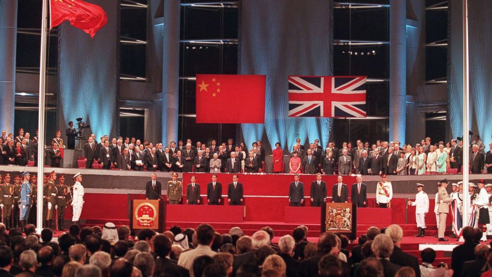 PHOTO: Officials participate in the handover ceremony, July 1, 1997, after the Chinese flag was raided (left) and the Union Jack was lowered.