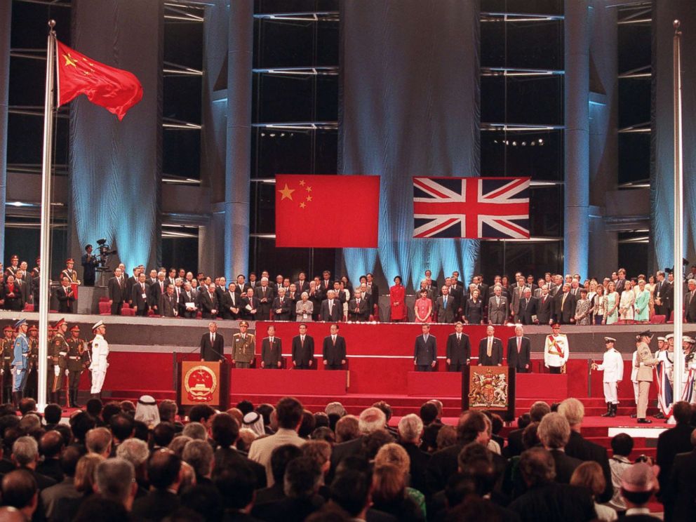   PHOTO: Officials participate in the handover ceremony on July 1, 1997, after the Chinese flag has been raided (left) and the Union Jack has been lowered. 