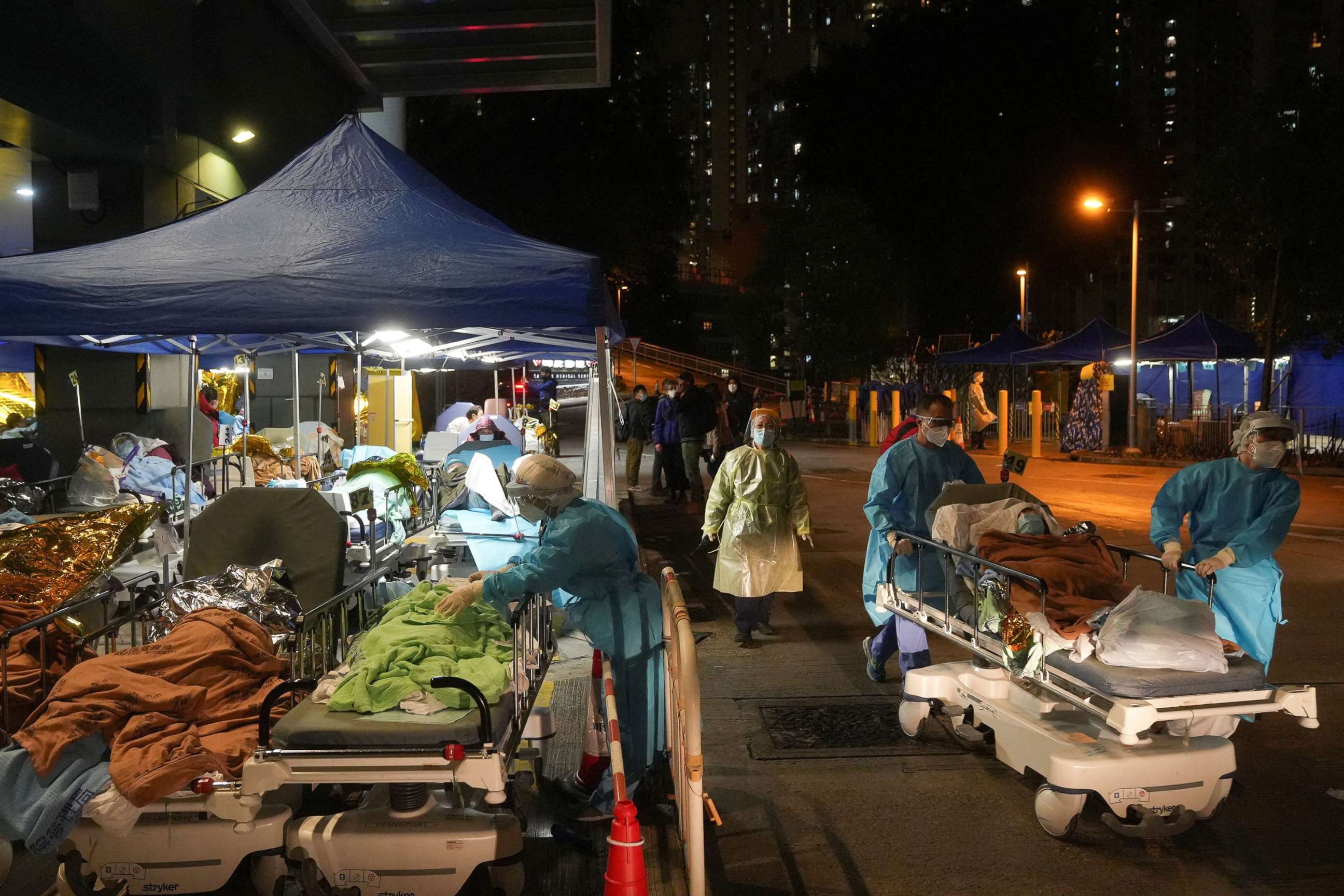 PHOTO: Medical workers tend to patients at a makeshift treatment area outside a hospital, during COVID-19 outbreak in Hong Kong, Feb. 17, 2022.