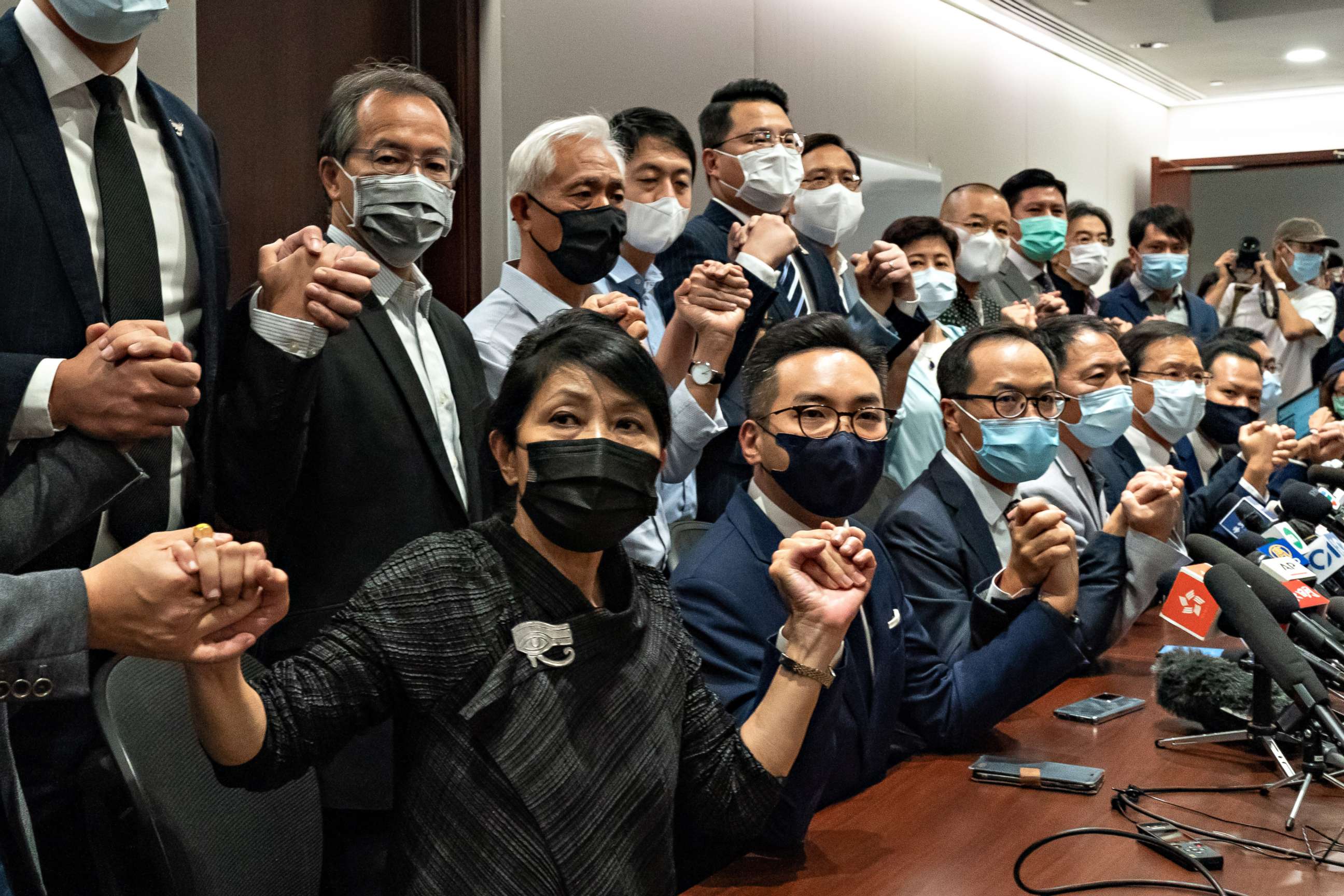 PHOTO: Pro-democracy lawmakers join hands during a press conference at the Legislative Council Building on Nov. 11, 2020, in Hong Kong.