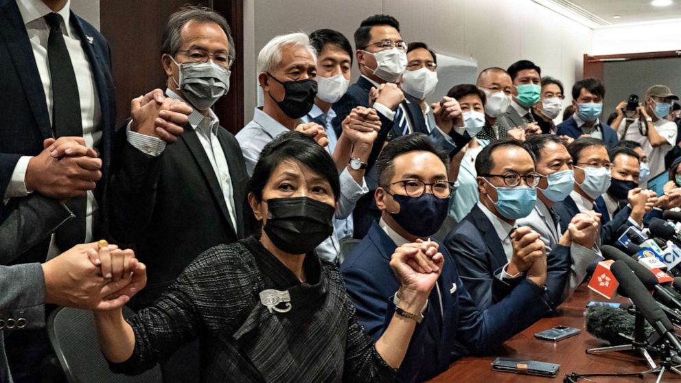 PHOTO: Pro-democracy lawmakers join hands during a press conference at the Legislative Council Building on Nov. 11, 2020, in Hong Kong.