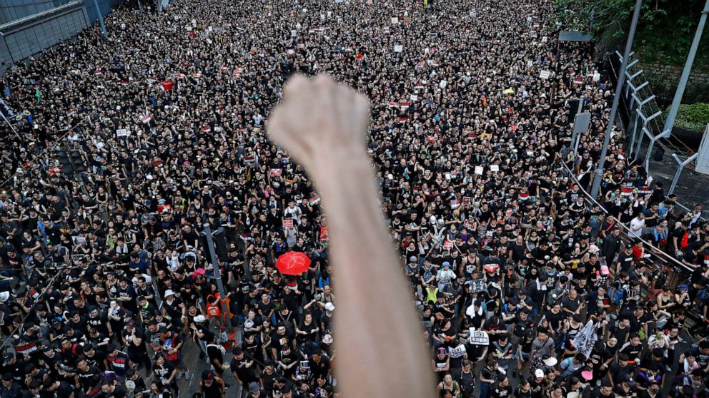 PHOTO: Demonstrators in Hong Kong march on the streets, June 16, 2019, to protest an extradition bill.