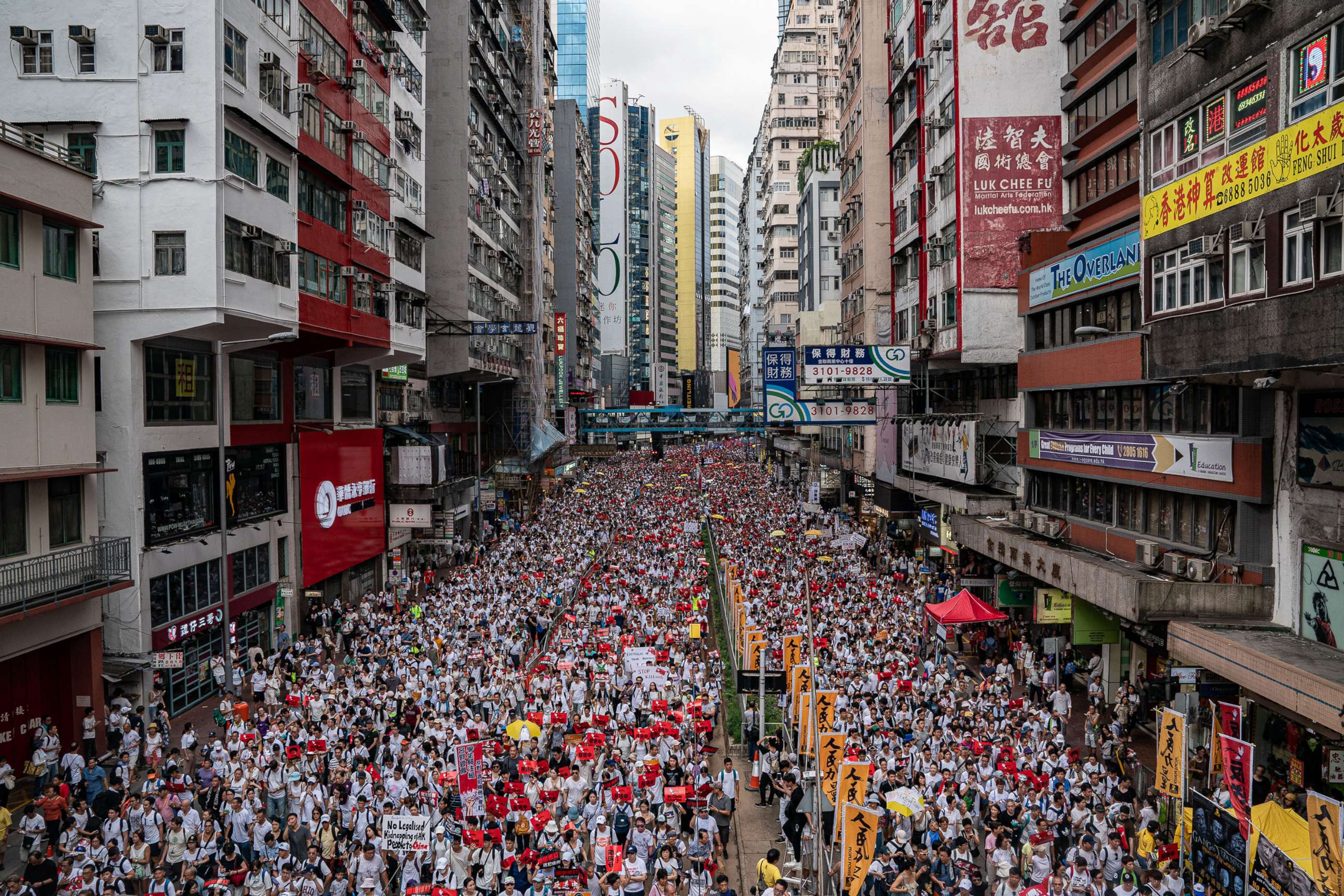 PHOTO: Protesters march on a street during a rally against the extradition law proposal, June 9, 2019, in Hong Kong.