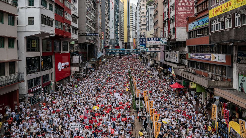 PHOTO: Protesters march on a street during a rally against the extradition law proposal, June 9, 2019, in Hong Kong.