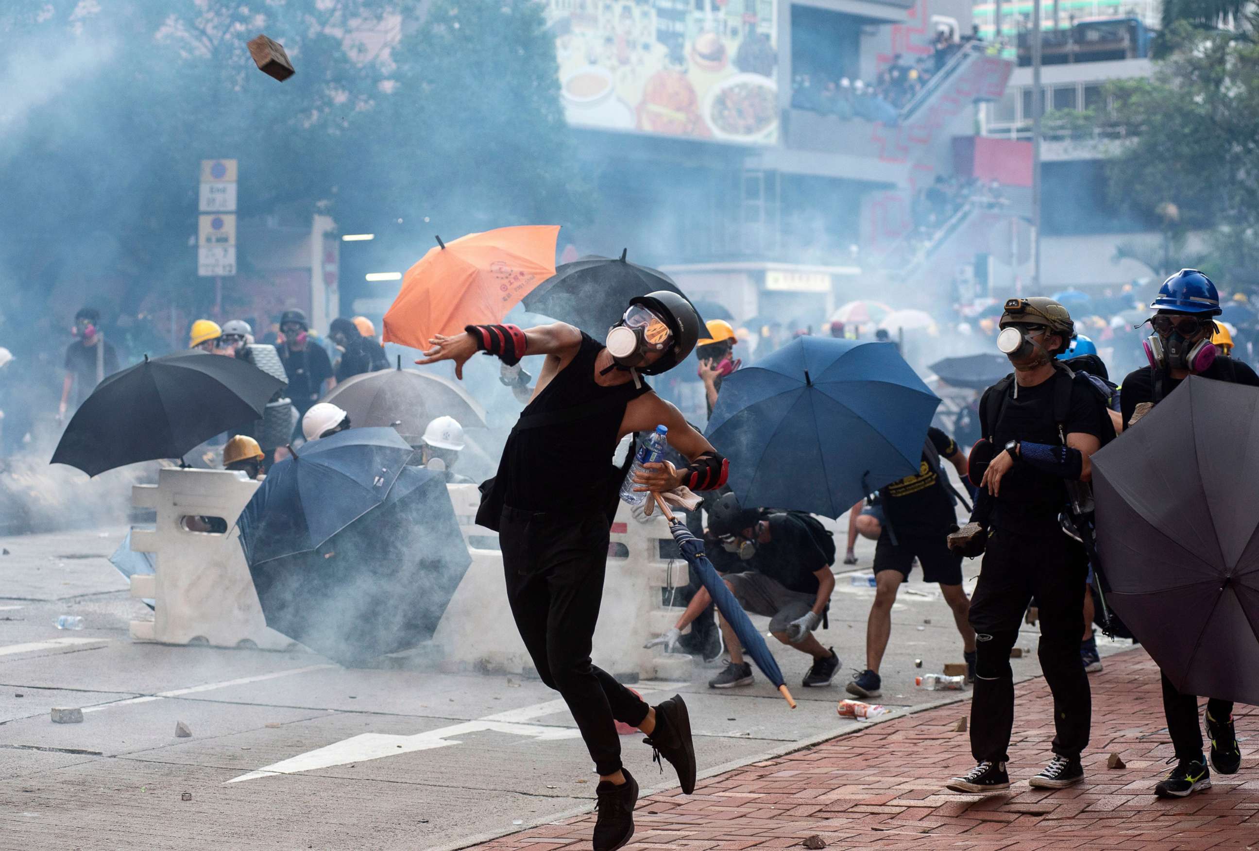 PHOTO: Anti-extradition protesters throw bricks after police fired tear gas at them during clashes in Wong Tai Shin area in Hong Kong, China, Aug. 5, 2019.