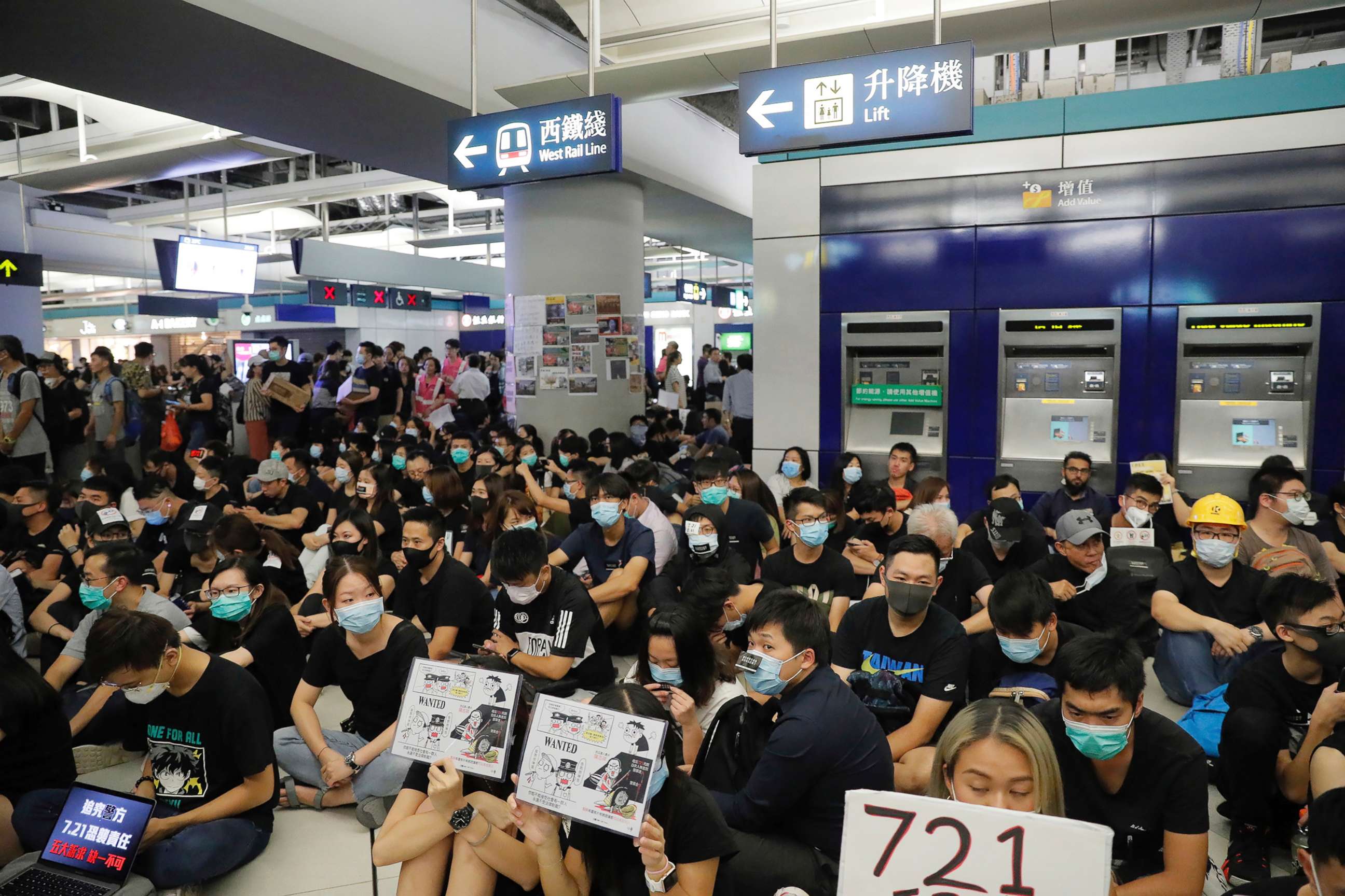 PHOTO: Demonstrators sit during a protest at the Yuen Long MTR station, where demonstrators and others were violently attacked by men in white T-shirts following an earlier protest in July, in Hong Kong, Aug. 21, 2019.