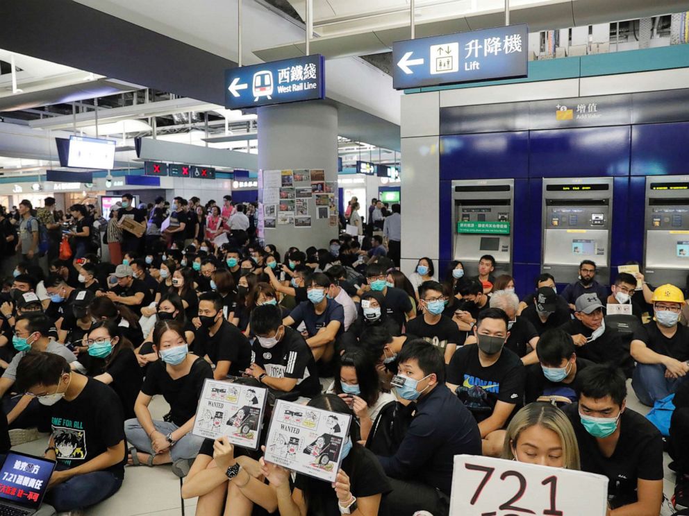 PHOTO: Demonstrators sit during a protest at the Yuen Long MTR station, where demonstrators and others were violently attacked by men in white T-shirts following an earlier protest in July, in Hong Kong, Aug. 21, 2019.