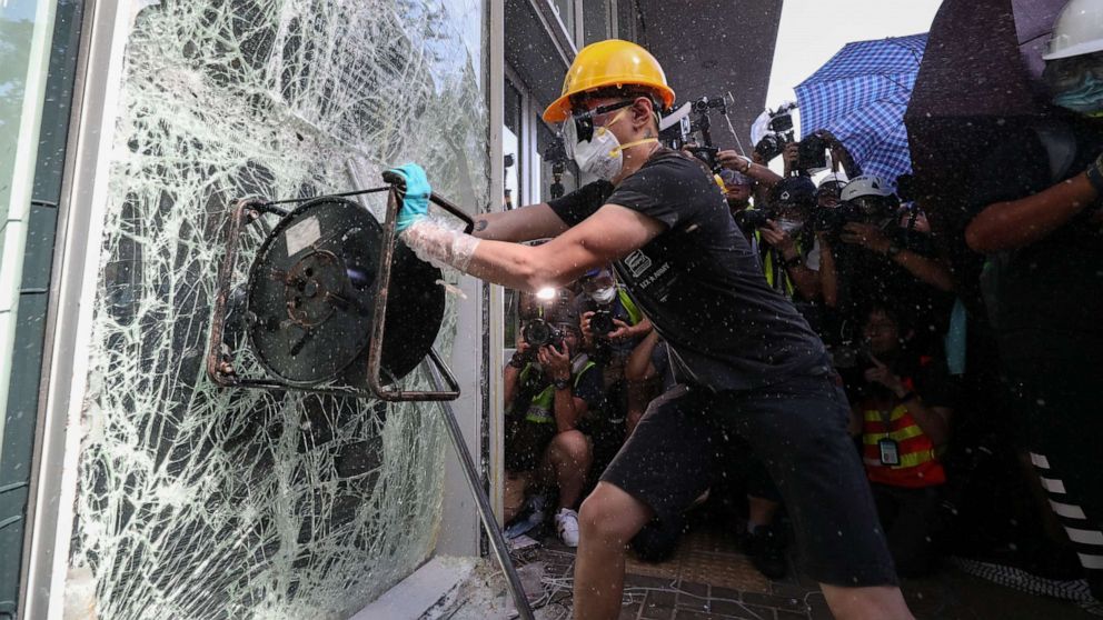 PHOTO: A protester breaks a window of the Legislative Council in Hong Kong, July 1, 2019.