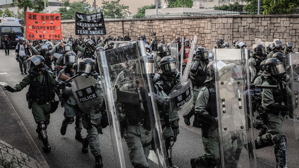 PHOTO: Riot police agents march to clear the surroundings of Legco during a pro-democracy protest in Hong Kong, Sep 15, 2019.