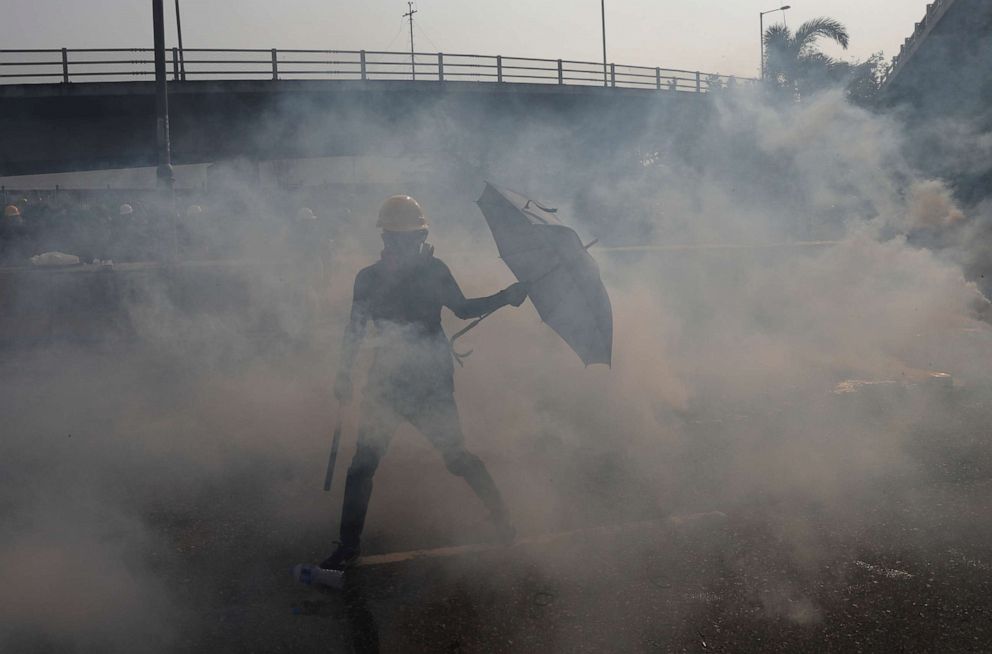 PHOTO: Tear gas floats in the air as demonstrators clash with riot police during a protest at Kowloon Bay in Hong Kong, China, August 24, 2019.