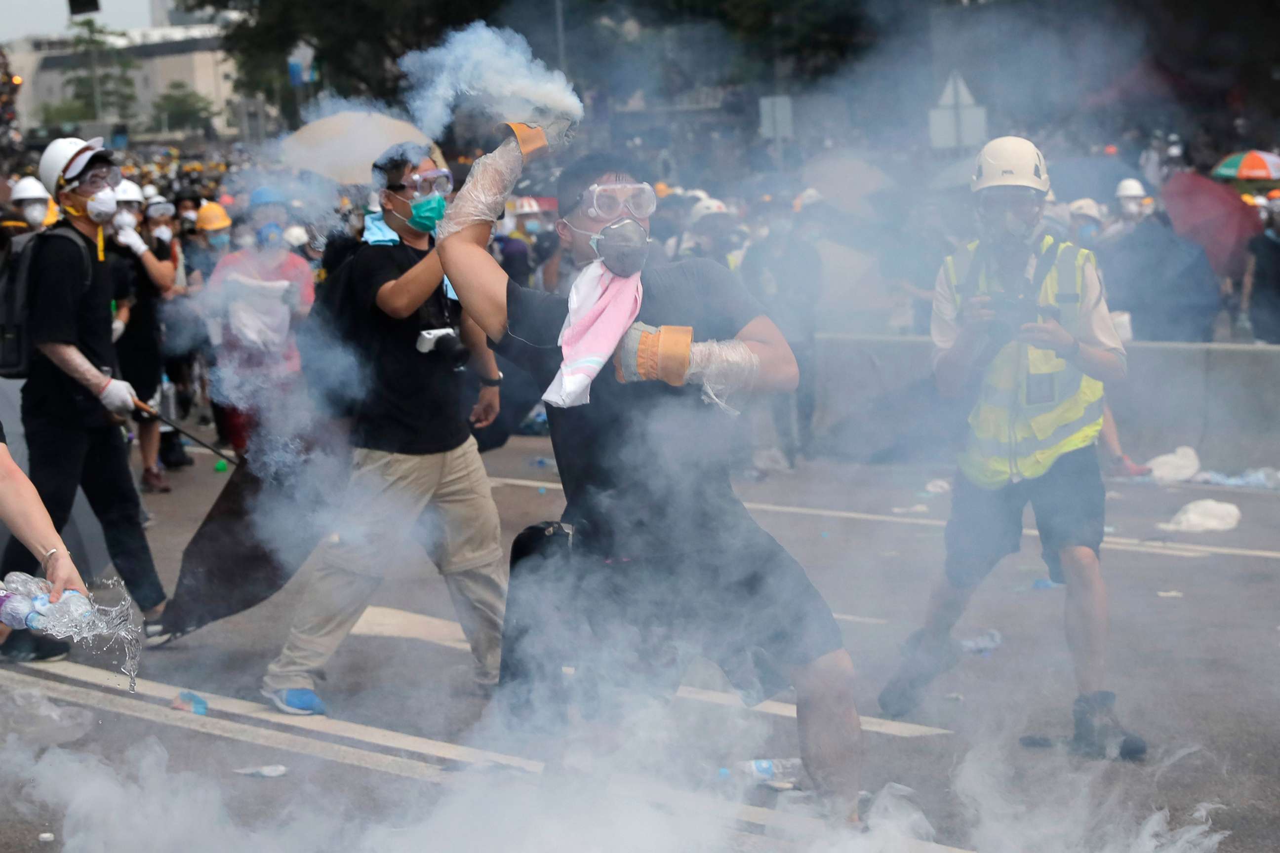 PHOTO:A demonstrator throws a canister of tear gas back towards the police outside the Legislative Council in Hong Kong,  June 12, 2019.