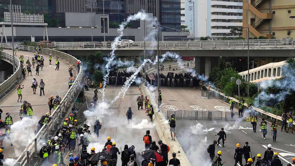 PHOTO: Clouds of smoke rise from tear gas canisters as police and demonstrators clash during a protest in Hong Kong, Saturday, Aug. 24, 2019.