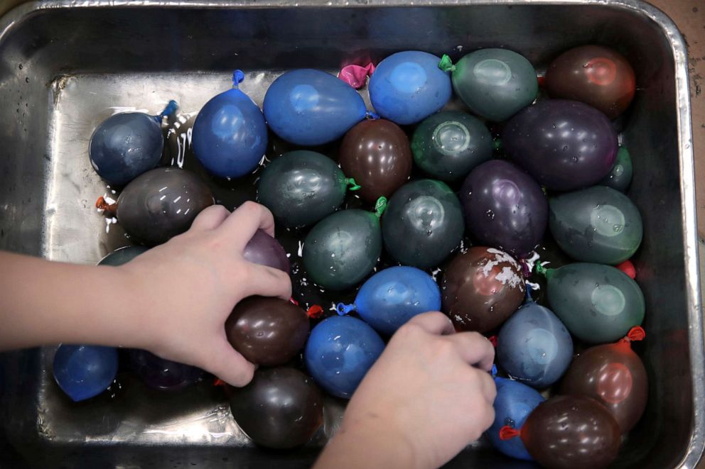 PHOTO: A protester fills balloons with paint and water at the Hong Kong Polytechnic University in Hong Kong, Nov. 15, 2019.