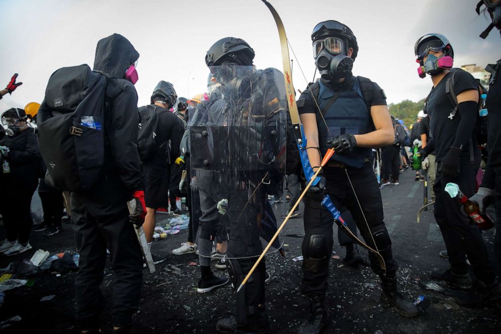 PHOTO: Students with bows and arrows, along with homemade weapons, take their position outside the Chinese University of Hong Kong, in Hong Kong, Nov. 13, 2019.