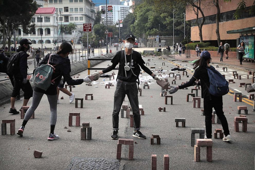 PHOTO: Protesters move bricks as they barricade a road near the Hong Kong Polytechnic University in Hong Kong, Nov. 14, 2019.