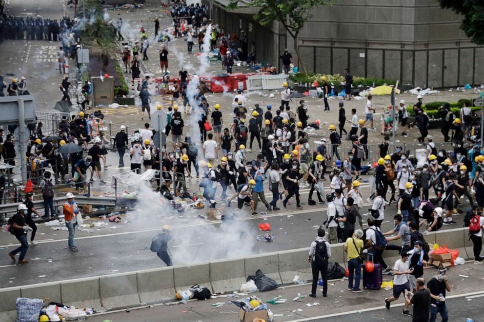 PHOTO: Riot police fire tear gas to protesters outside the Legislative Council in Hong Kong, June 12, 2019.