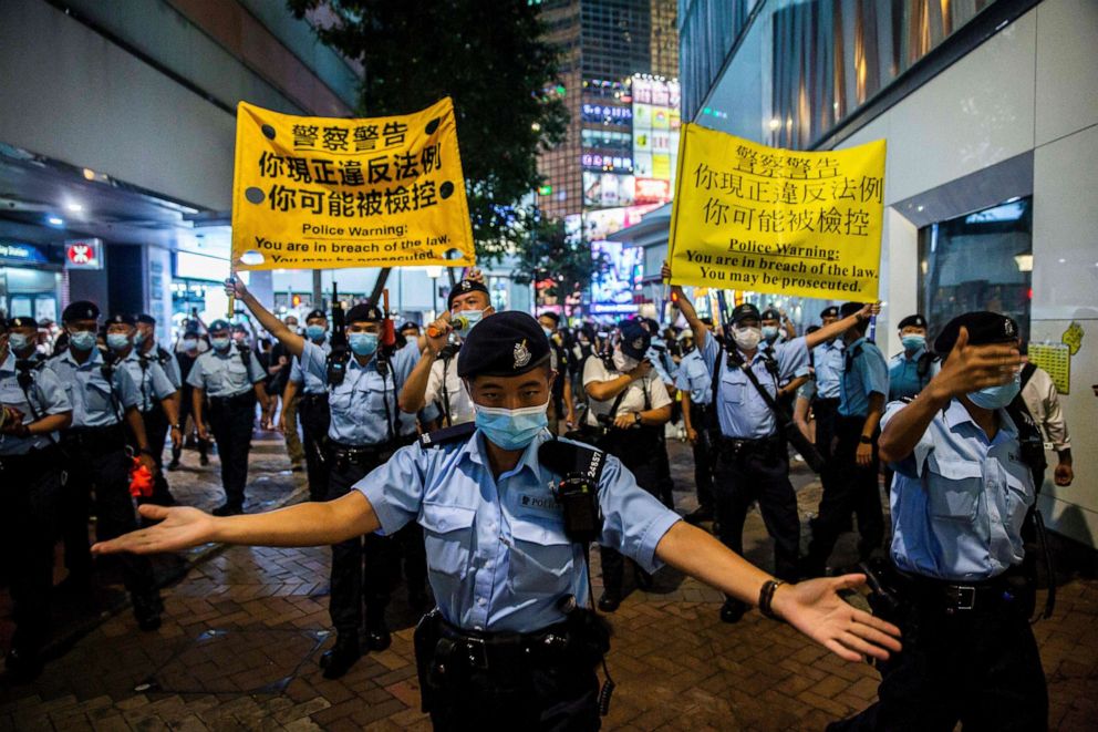PHOTO: Police move people on as they gathered in the Causeway Bay district of Hong Kong on June 4, 2021.